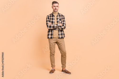 Full size photo of mature man folded hands standing wear casual clothes representative isolated over beige color background