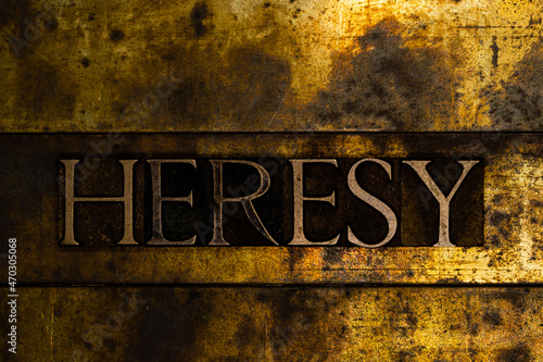 Heresy text message on textured grunge copper and vintage gold background