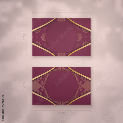 Burgundy business card with Indian gold pattern for your contacts. photo