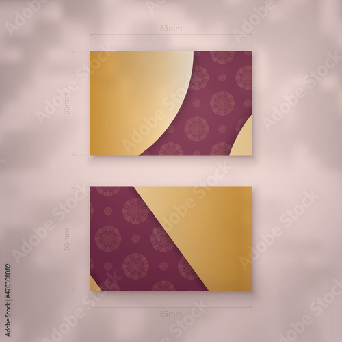 Burgundy business card with vintage gold ornaments for your personality. photo