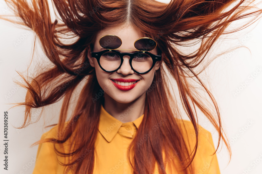red-haired woman wearing sunglasses posing fashion light background red-haired woman wearing sunglasses posing fashion light background