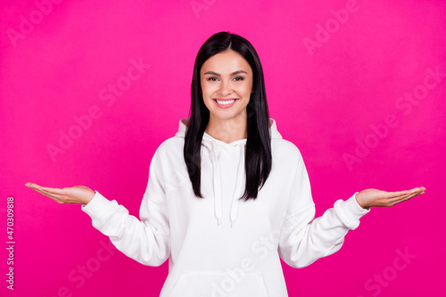 Photo of young girl promoter hold hands proposition weighing measure ads isolated over magenta color background