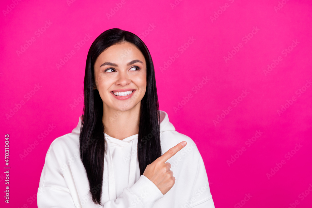 Photo of young cheerful girl look point finger empty space direct way ads suggest discount isolated over magenta color background Photo of young cheerful girl look point finger empty space direct way ads suggest discount isolated over magenta color background