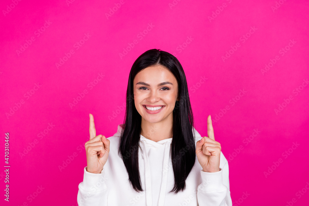 Photo of young attractive girl point fingers empty space promotion suggest direct isolated over magenta color background Photo of young attractive girl point fingers empty space promotion suggest direct isolated over magenta color background