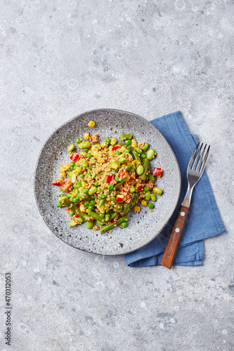 Quinoa salad with green beans, corn, red bell peppers, peas and soybeans. Useful vegetable mix