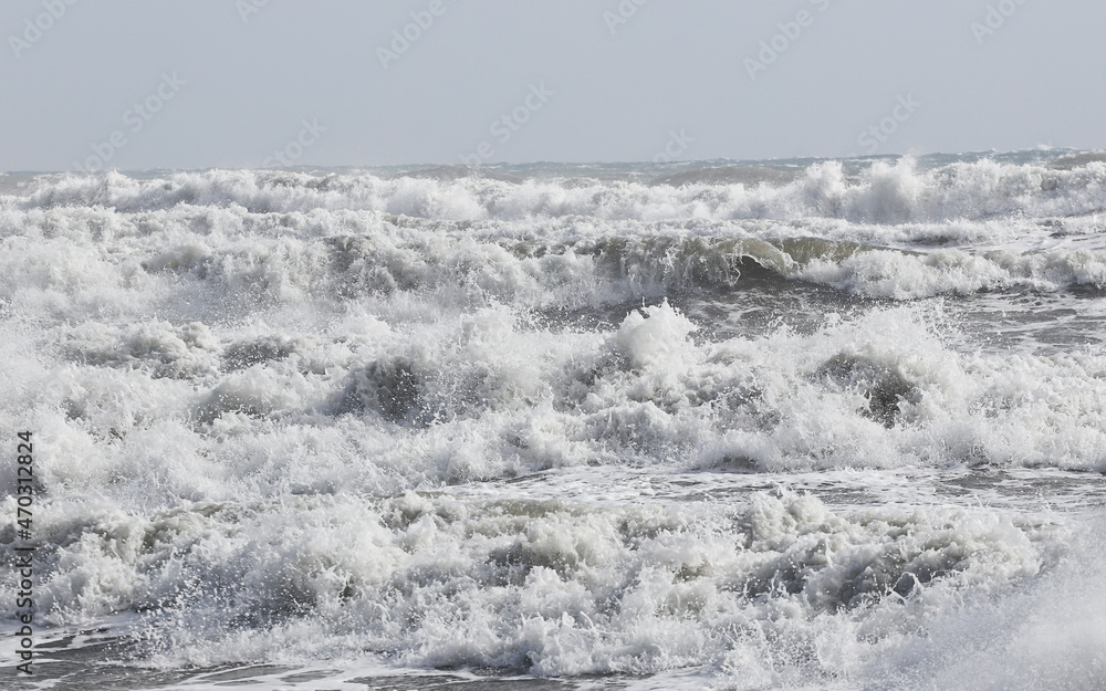big waves breaking on the shore, with white foam big waves breaking on the shore, with white foam