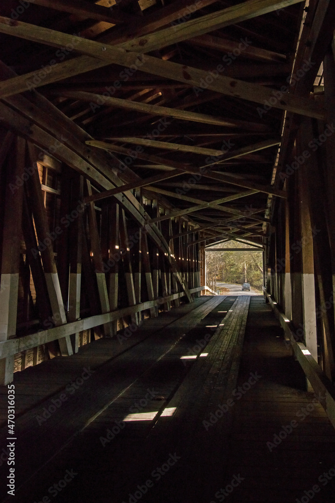 A car exits the far end of a covered bridge in Parke County, Indiana. A car exits the far end of a covered bridge in Parke County, Indiana.