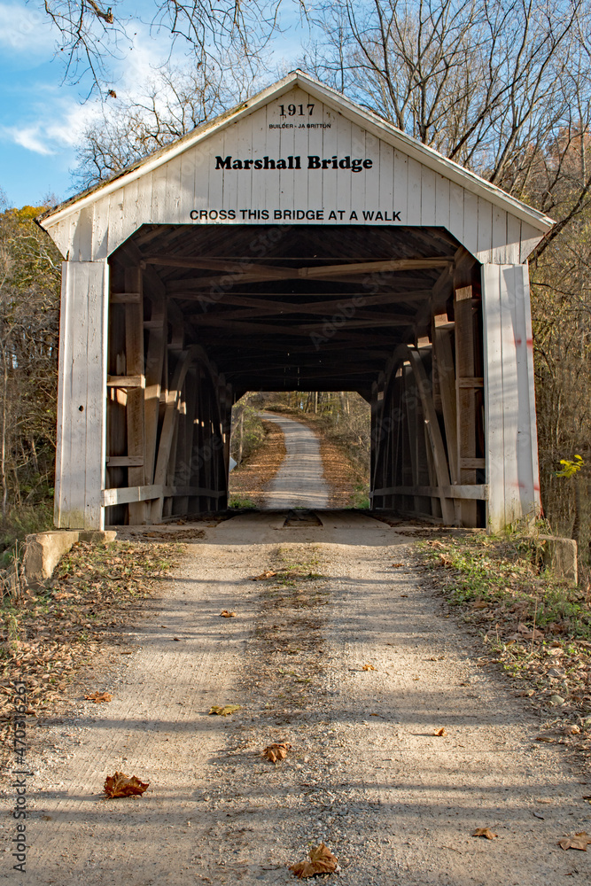 A lonely gravel lane runs through a covered bridge in Parke County, Indiana A lonely gravel lane runs through a covered bridge in Parke County, Indiana