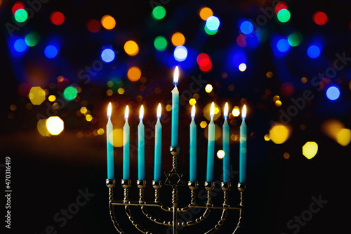 Jewish holiday Hanukkah beautiful festive bokeh background with traditional menorah and candles