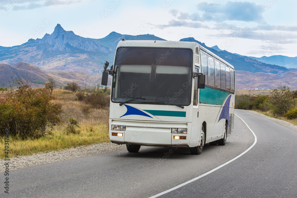 Tourist bus moves along mountain road