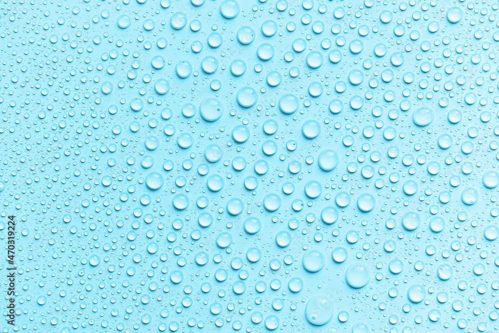 Water drops on a blue background. Round drops on waterproof material. Texture. The concept of freshness and purity. Splashes, condensation. Water drops on a blue background. Round drops on waterproof material. Texture. The concept of freshness and purity. Splashes, condensation.