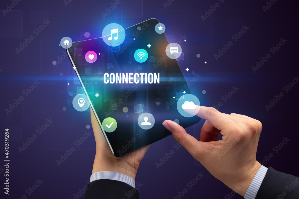 Businessman holding a foldable smartphone Businessman holding a foldable smartphone