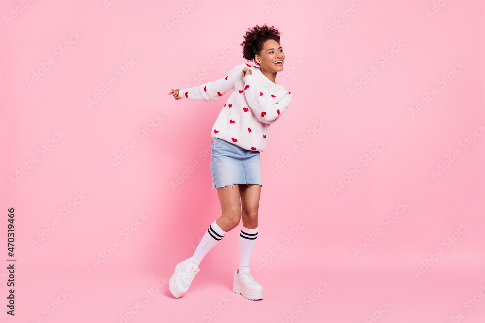 Photo of funky sweet african lady dressed white sweater dancing looking empty space smiling isolated blue color background Photo of funky sweet african lady dressed white sweater dancing looking empty space smiling isolated blue color background