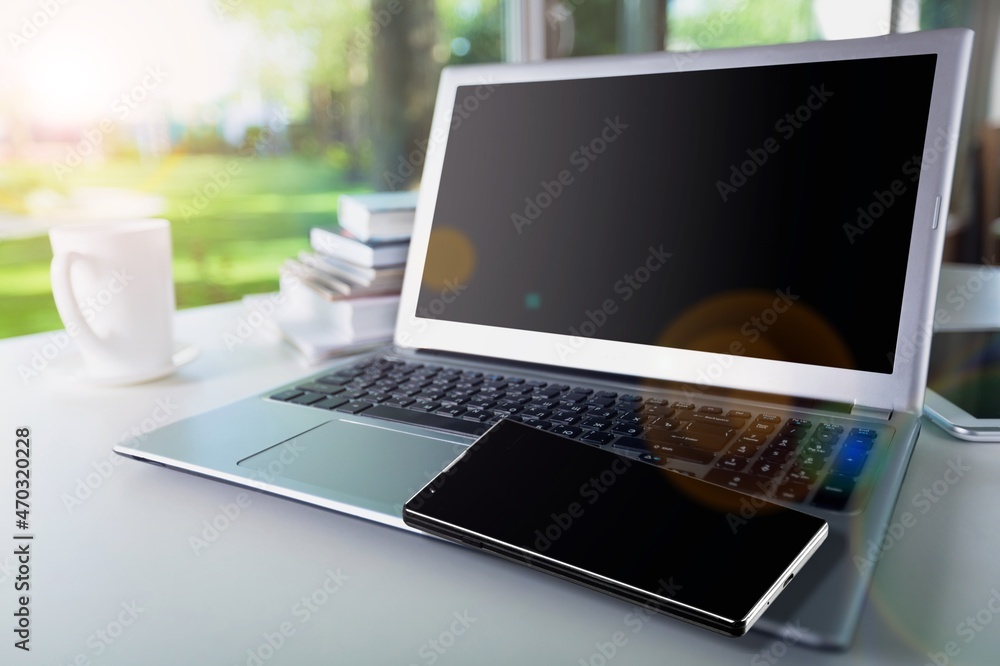 Modern smartphone with a blank screen and laptop Modern smartphone with a blank screen and laptop