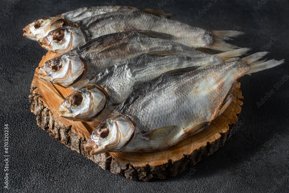 Ready-made silver bream fish, dried, dry, salted, appetizing laid out on a dark background. Catch river, fishing.