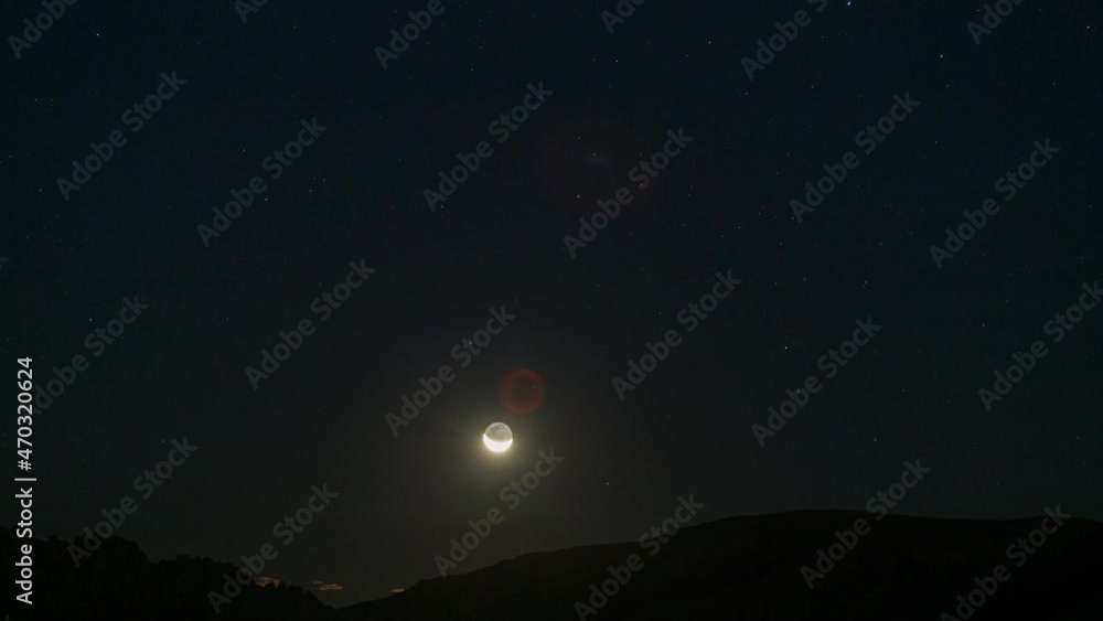 Time lapse of crescent moon rising over horizon in Mojave Desert, California Time lapse of crescent moon rising over horizon in Mojave Desert, California