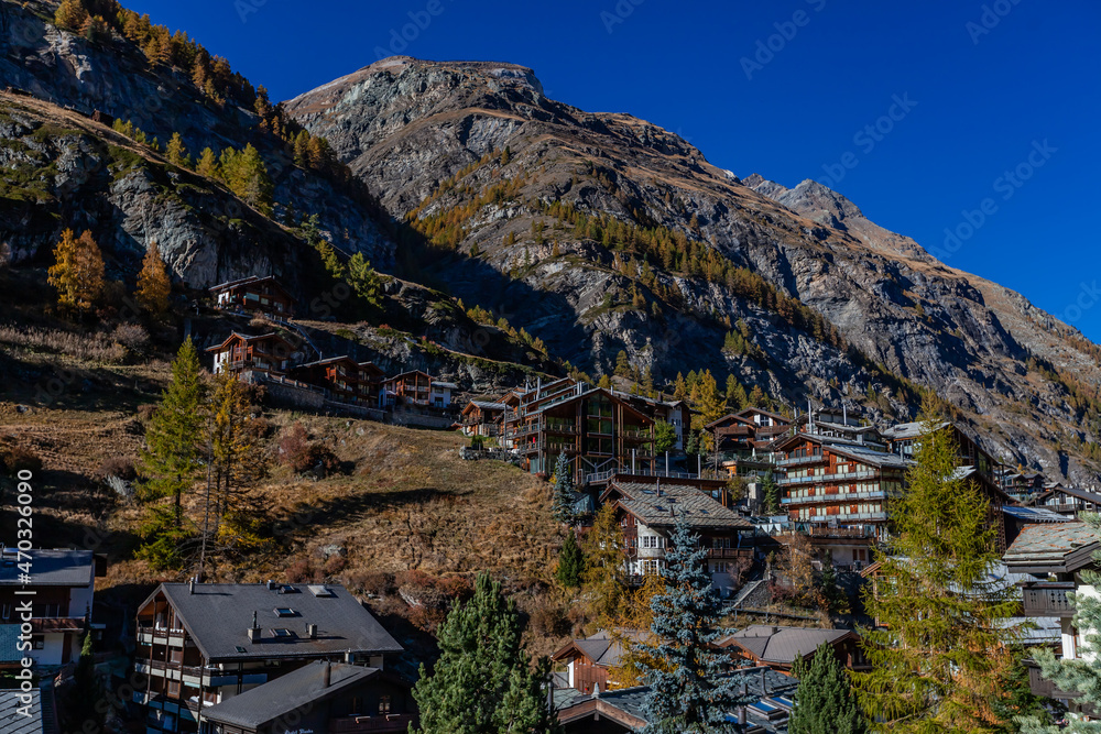 Fototapeta premium Spectacular alpine landscape, mountain Swiss wooden chalet with high mountains in background, Zermatt, Switzerland. October, 2021.