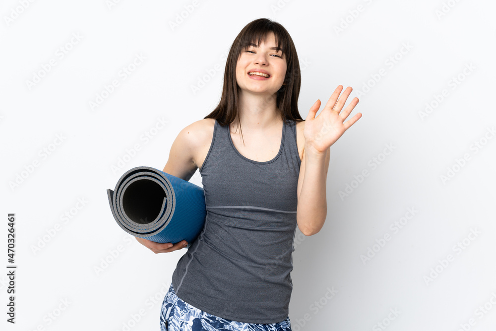 Ukrainian sport girl with mat isolated on blue background saluting with hand with happy expression Ukrainian sport girl with mat isolated on blue background saluting with hand with happy expression
