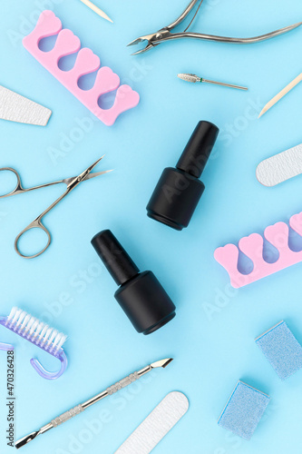 Fototapeta Naklejka Na Ścianę i Meble -  Set of cosmetic tools for manicure and pedicure on blue background