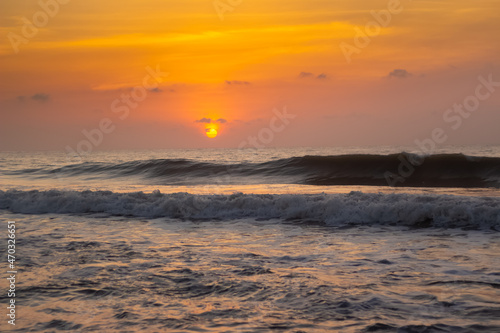 Beautiful sunrise over the beach.  Red sky in bay of bengal. Sea Waves photography. photo