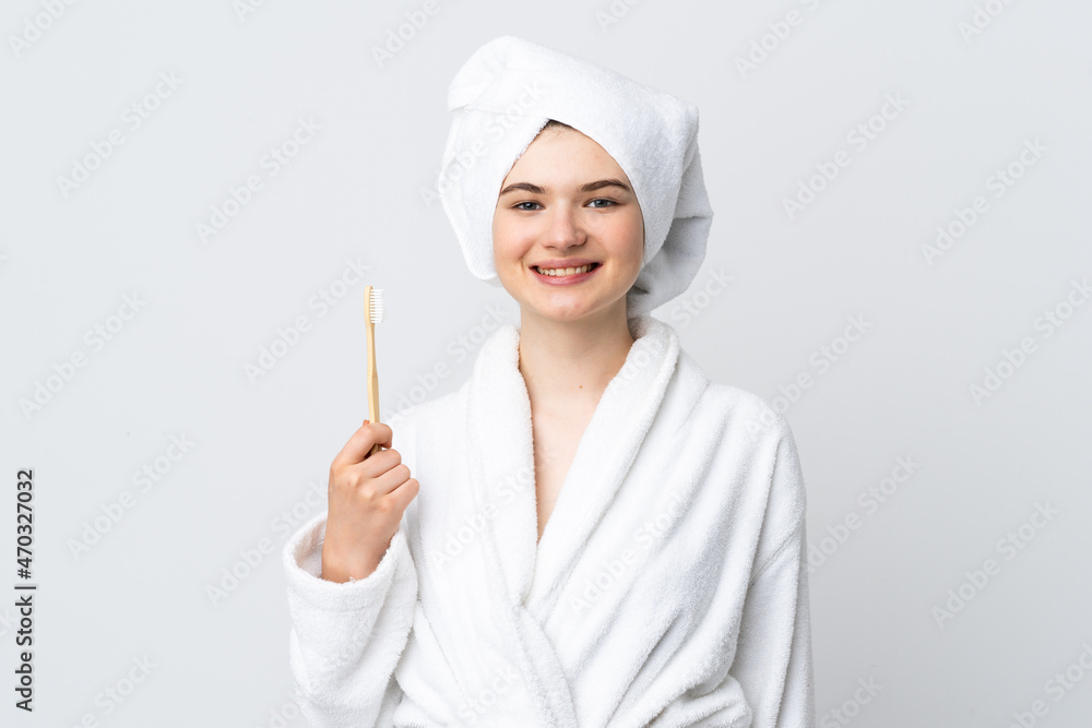 Young woman in a bathrobe holding toothbrush smiling a lot Young woman in a bathrobe holding toothbrush smiling a lot