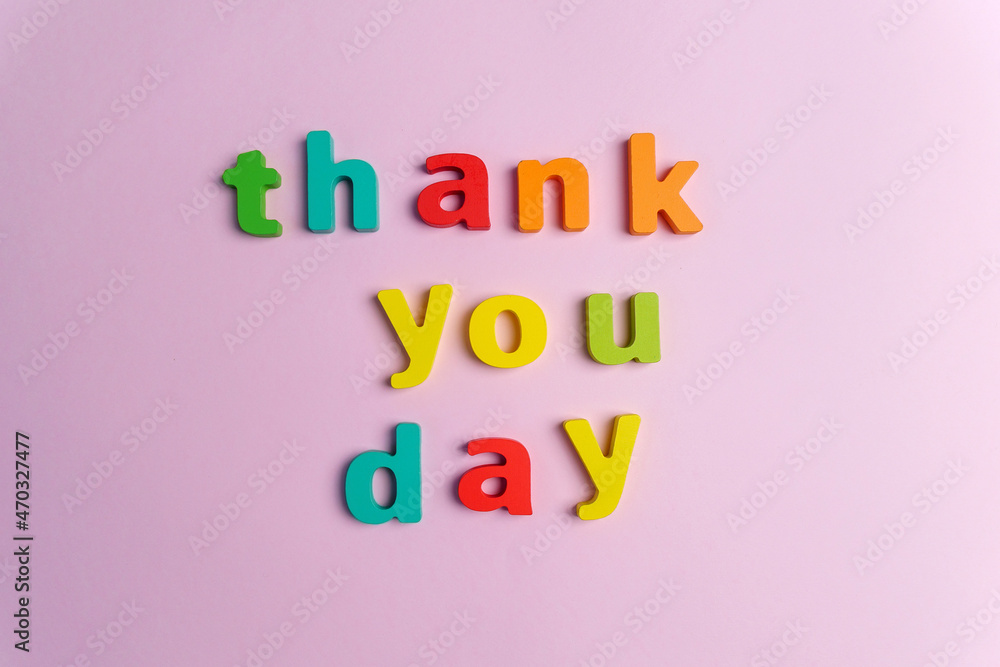 Creative flat play with the text thank you day. Top view. Pink background Creative flat play with the text thank you day. Top view. Pink background