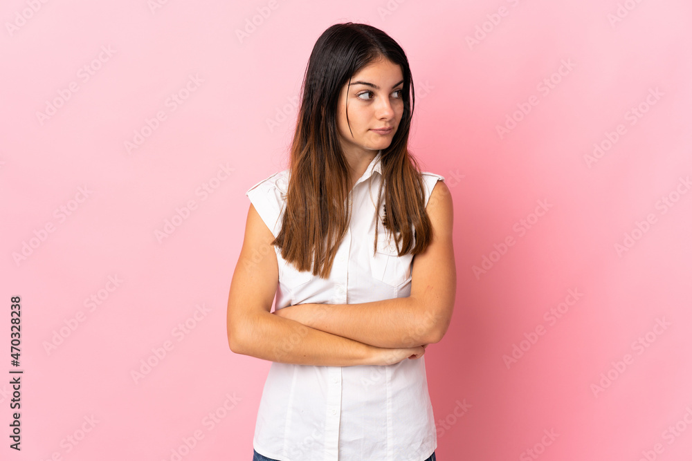 Young caucasian woman isolated on pink background keeping the arms crossed Young caucasian woman isolated on pink background keeping the arms crossed