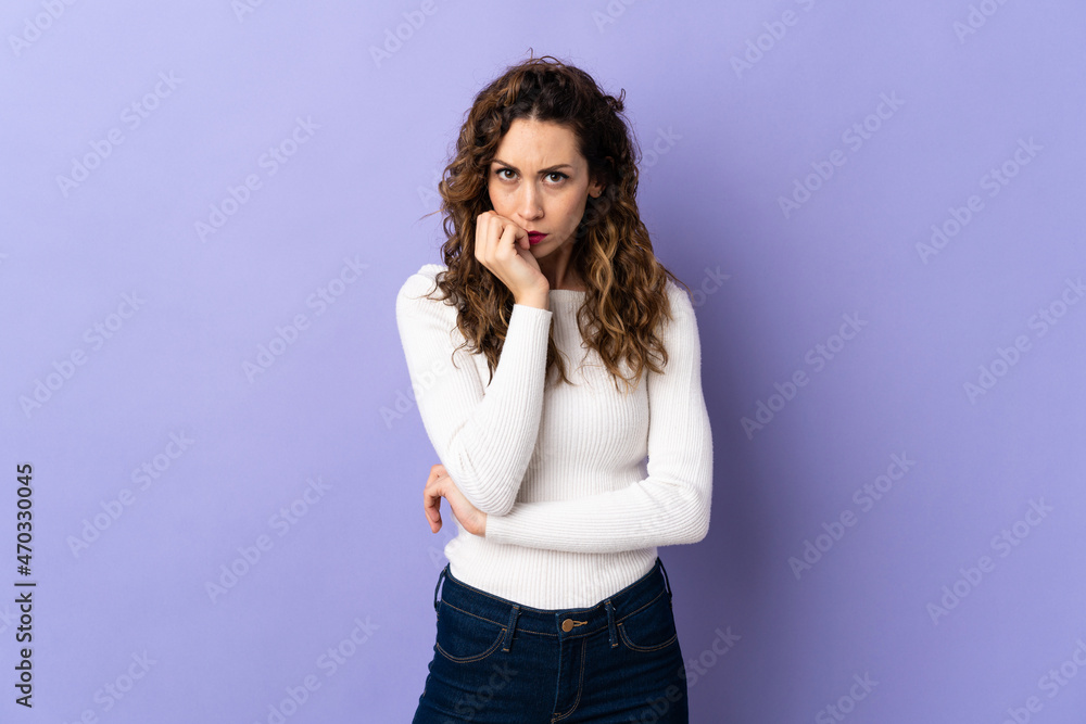 Young caucasian woman isolated on purple background having doubts Young caucasian woman isolated on purple background having doubts