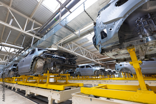 Car bodies are on assembly line. Factory for production of cars. Modern automotive industry