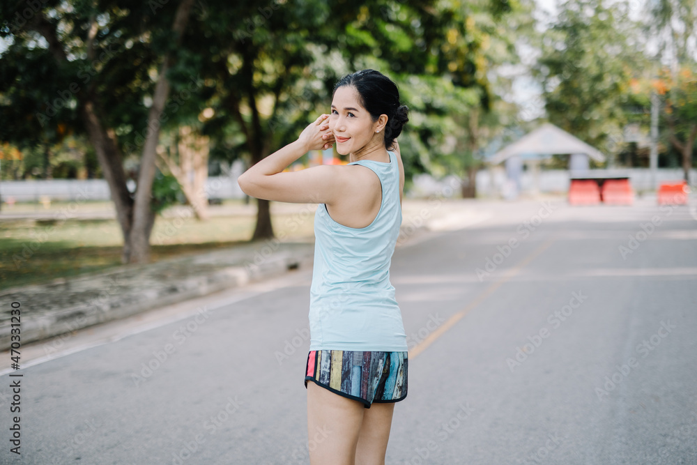 A beautiful woman stretching her body before going for a run in the morning.women's health care concept A beautiful woman stretching her body before going for a run in the morning.women's health care concept