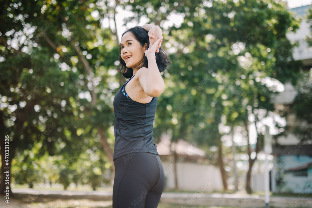 A beautiful woman stretching her body before going for a run in the morning.women's health care concept A beautiful woman stretching her body before going for a run in the morning.women's health care concept