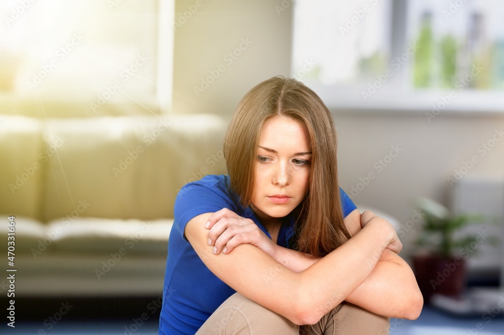 Joyless woman standing alone indoor. Tiredness, lack of optimism, solitude, life concerns concept Joyless woman standing alone indoor. Tiredness, lack of optimism, solitude, life concerns concept