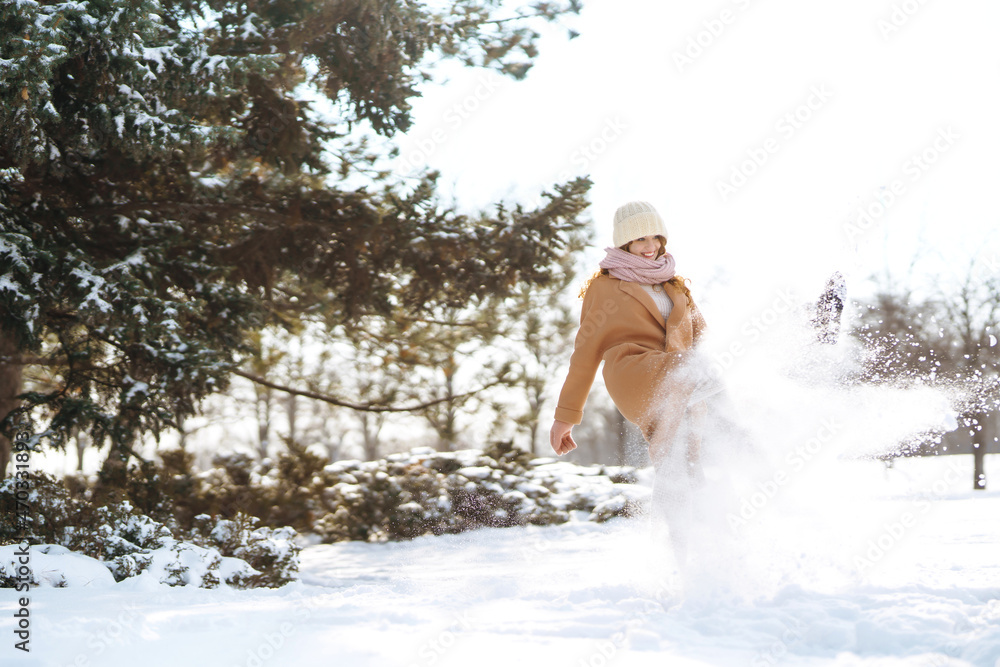 Happy woman in winter style clothes walking in the snowy forest. Nature, holidays, rest, travel concept. Happy woman in winter style clothes walking in the snowy forest. Nature, holidays, rest, travel concept.