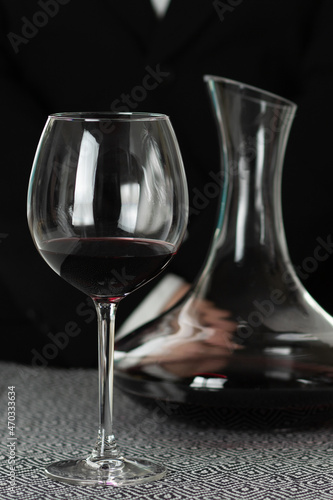 waiter in a restaurant with a glass of wine and a decanter
