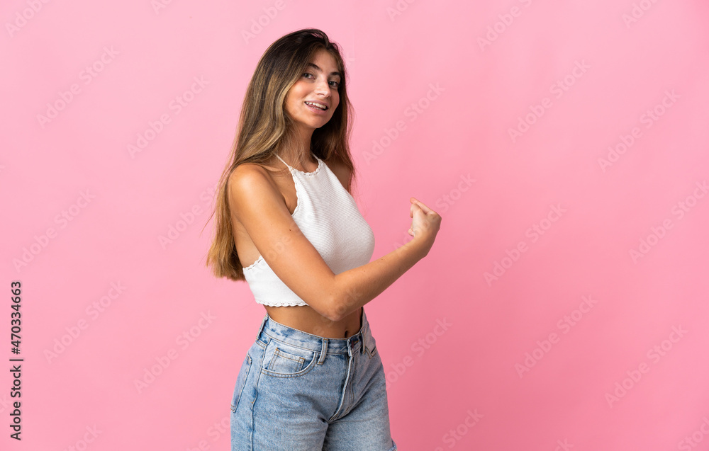 Young caucasian woman isolated on pink background pointing back Young caucasian woman isolated on pink background pointing back