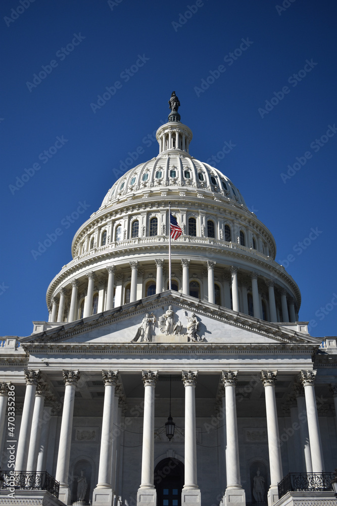 Fototapeta premium Washington, DC, USA - November 1, 2021: Looking Up at the U.S. Capitol Building from the Stairs on the East Side on a Bright, Clear Day in Autumn 