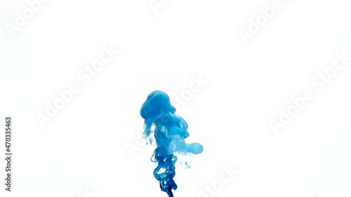 Deep blue color paint flow floats in clear water create decorative abstract background with copy space slow motion extreme closeup
