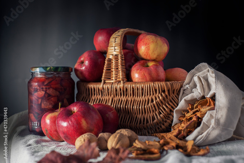 Dramatic still life of various fruits and jars of jam