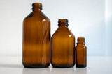 various amber glass bottles for cosmetics, natural medicine , essential oils or other liquids isolated on a white background, top view
