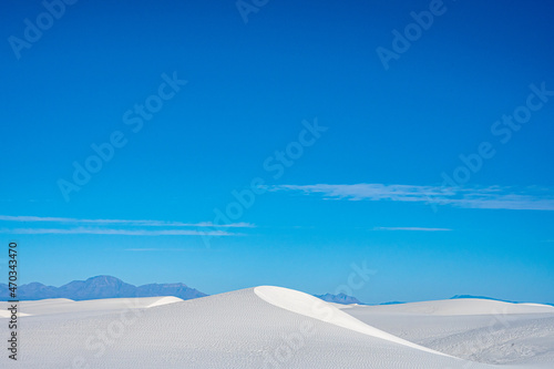 Curving Peak Of A Dune Under A Blue Sky © kellyvandellen