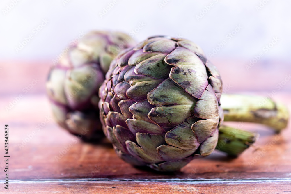 Fototapeta premium A close up of globe artichokes on a table, with a shallow depth of field