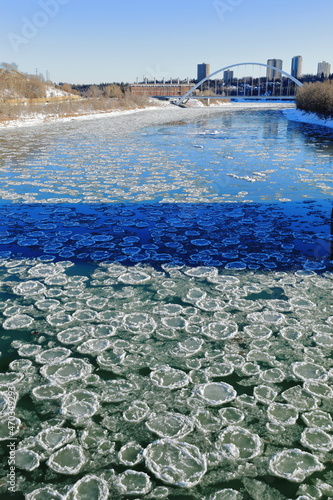 Frazil pancake ice with bridge in background