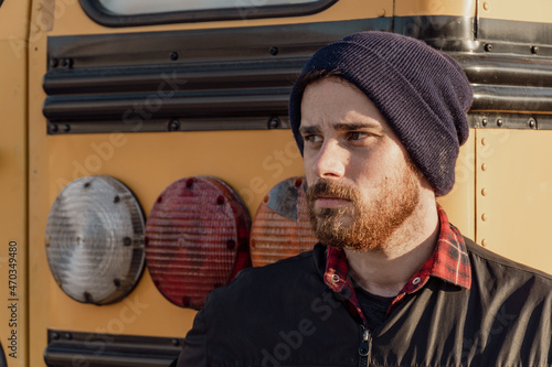 Young stylish hipster man looking out when exiting a bus