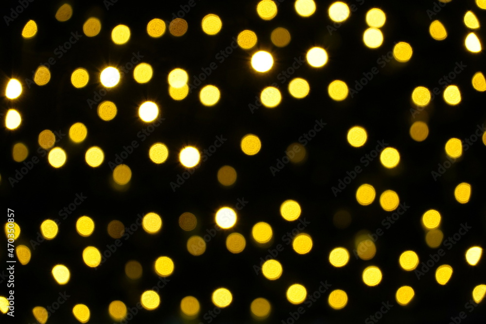 Defocuses Christmas lights in yellow shades on a Christmas tree outdoors at night. Suitable as Christmas or seasonal background. Defocuses Christmas lights in yellow shades on a Christmas tree outdoors at night. Suitable as Christmas or seasonal background.