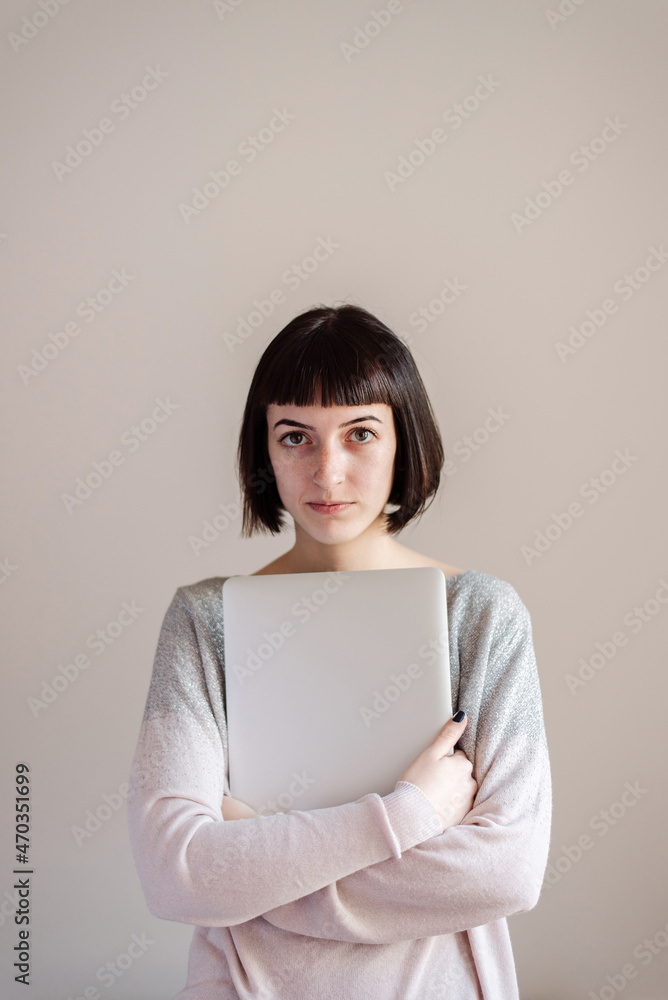 Portrait of young student, she is holding files and laptop Portrait of young student, she is holding files and laptop