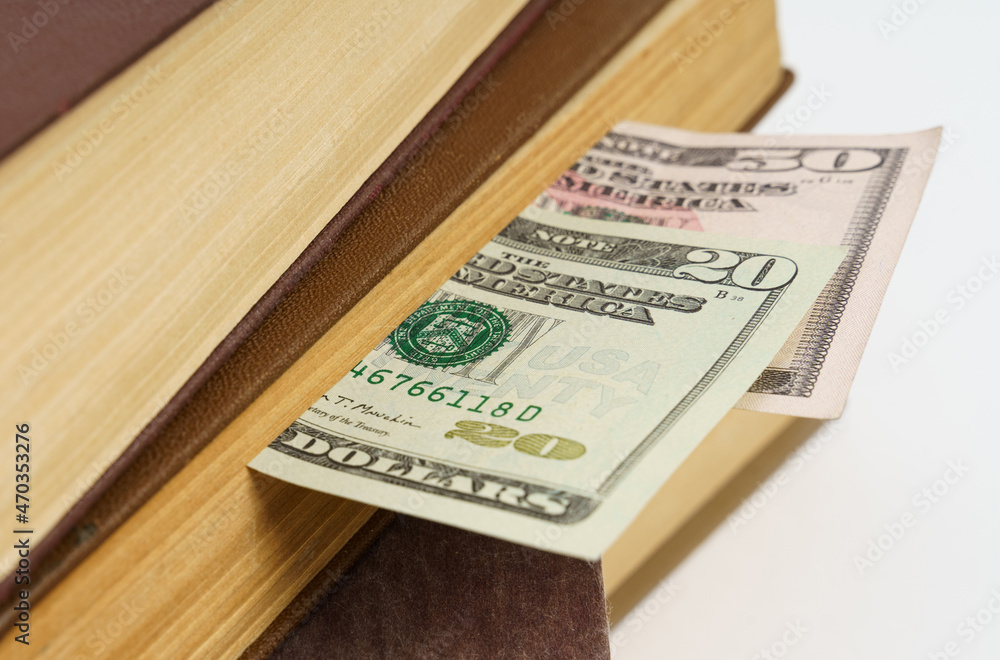 In the book, dollar bills lie between the pages. In the book, dollar bills lie between the pages.