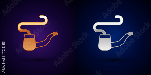 Gold and silver Smoking pipe with smoke icon isolated on black background. Tobacco pipe. Vector