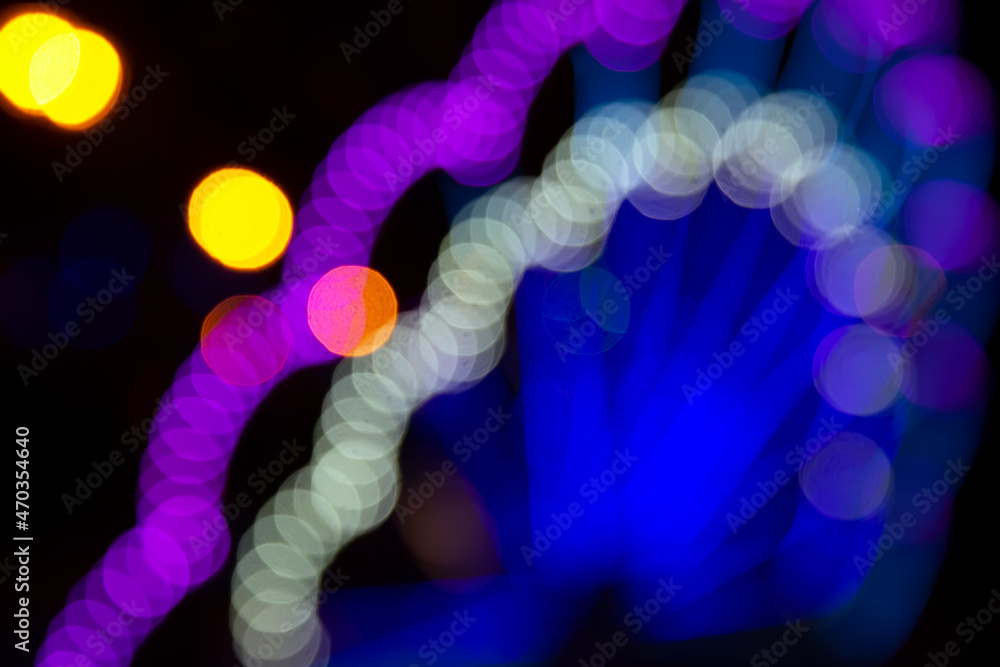 Colored blurred bokeh. abstract background of included festive garlands. colorful blur light bulbs Colored blurred bokeh. abstract background of included festive garlands. colorful blur light bulbs