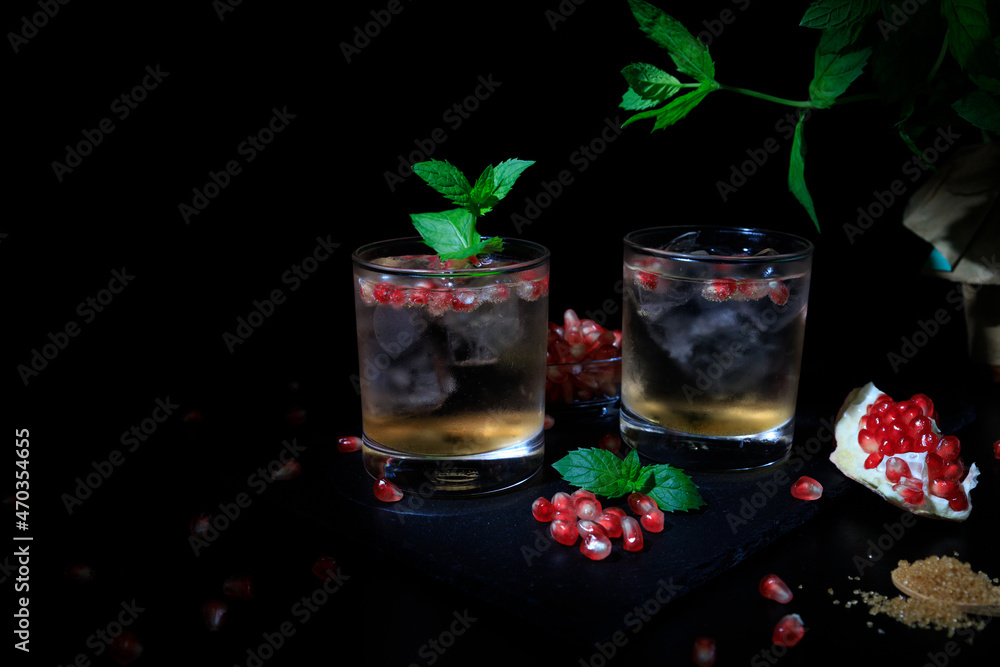 Two summer cocktails with pomgranate, mint and some sugar. flat lay and black background Two summer cocktails with pomgranate, mint and some sugar. flat lay and black background