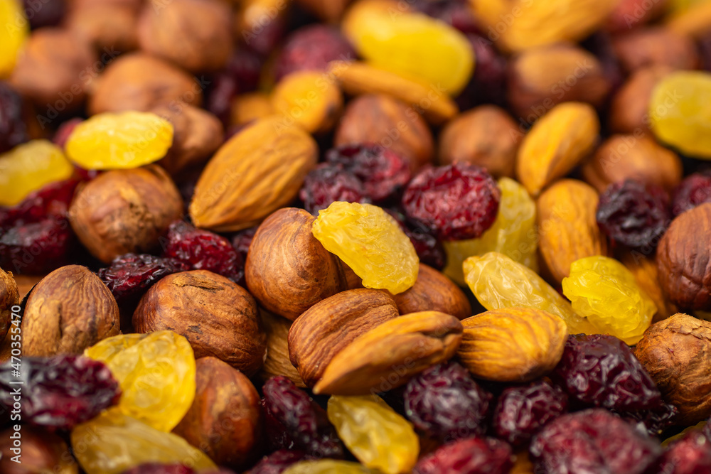 Mix of dried fruits. Healthy snacks. Almonds, raisins, hazelnuts, cranberries. Assorted nuts and dried berries. Selective focus, focus on the front. Healthy food concept Mix of dried fruits. Healthy snacks. Almonds, raisins, hazelnuts, cranberries. Assorted nuts and dried berries. Selective focus, focus on the front. Healthy food concept
